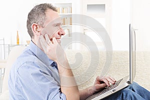 Hearing impaired man working with laptop