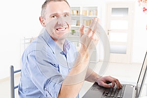 Hearing impaired man working with laptop