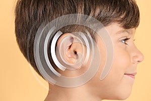 Hearing loss concept. Little boy and sound waves illustration on yellow background, closeup