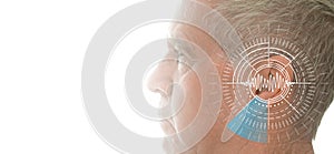 Hearing test showing ear of senior man with sound waves simulation technology photo