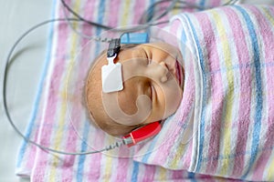 Hearing test of a sleeping newborn at hospital