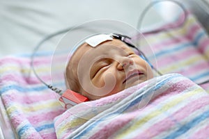 Hearing test of a sleeping newborn at hospital