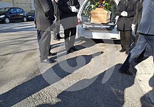 Hearse with coffin and gravediggers