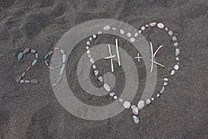 Heart and 29 made from Stones on a Sand Beach