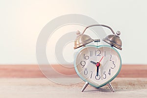 Heart alarm clock on table,