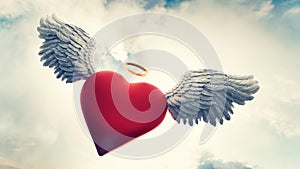 Heart with angel wings and gold ring flying in clouds