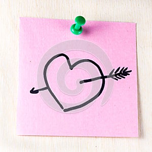 Heart with arrow on paper post it