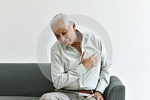 Heart attack disease problem in old man, Elderly asian man with hand on chest gesture.