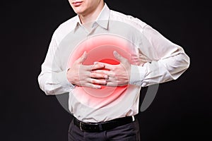 Heart attack, man with chest pain on black background