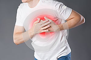 Heart attack, man with chest pain on gray background