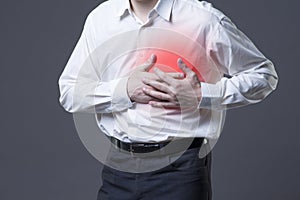 Heart attack, man with chest pain on gray background