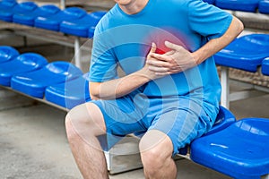 Heart attack, man with chest pain after workout on a sports ground