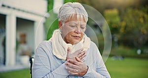 Heart attack, pain and senior woman in a garden with hands on chest, anxiety or breathing problem. Cardiac arrest