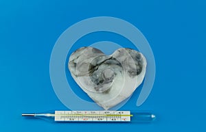 Heart is black with white color and a thermometer for measuring the temperature of the human body