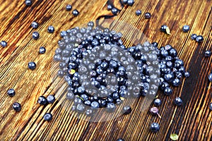 Heart of blueberries on wooden background