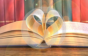 Heart and book. A open book with pages forming the heart, rank of books. s