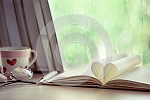 Heart book page on rainy day window background