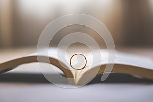 Heart from a book page and The ring placed on a bed