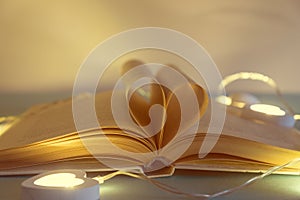 Heart from book pages. vintage style with bokeh in soft light at night ,blur background, copy space, concept for valentine`s day