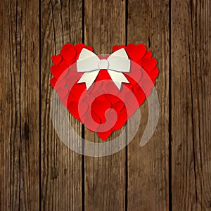 Heart with a bow on a wooden background vector