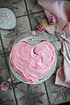 Heart cake with pink cream and confectionery toppings