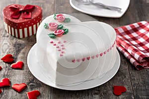 Heart cake for St. Valentine`s Day, Mother`s Day, or Birthday, decorated with roses and pink sugar hearts