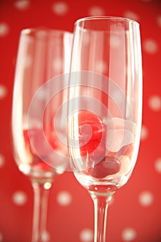 Heart candies in wine flutes against polka dots