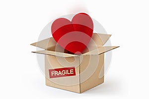 Heart in cardboard box with the Word Fragile - Concept of love and fragility