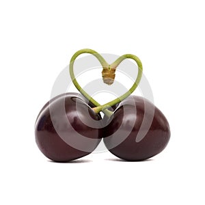 Heart chape from two sweet cherry on a white background photo