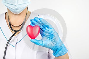 Heart Check. Concept healthcare. Medical worker with red heart in hand. Disease diagnosis medicine, healthcare and cardiology