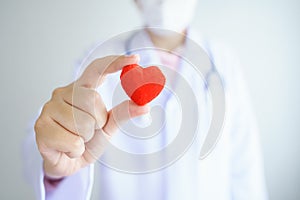 Heart check Doctor holding Red heart on hands at hospital office.Healthcare And Medical concept