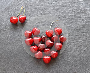 heart of cherries on a slate background