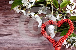 Heart with cherry blossoms on wooden desk