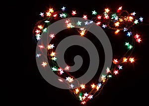 Heart from christmas lights on black background