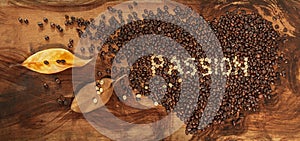 A heart of coffee beans with dry leaves of magnolia