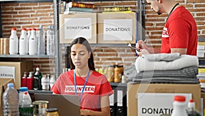 At the heart of community service, man and woman volunteers mastering technology, engrossed in laptop work, documenting donations