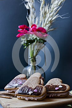 Heart cookies, dark background with flowers