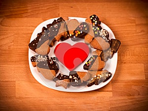 Heart cookies on a wooden brown background. Concept of Holiday Valentine`s Day or Christmas and New Year.