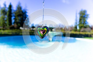 Heart crystal glass refract sunlight - fountain background