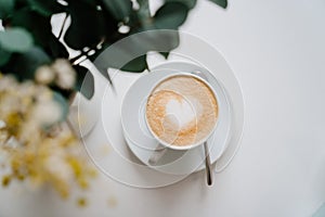 heart. cup with a cappuccino on a wooden table. Delicious coffee. top view