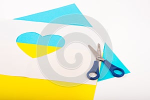 heart cut out of paper and painted in blue and yellow colors as symble of Ukraine. Creativity as support of Ukraine