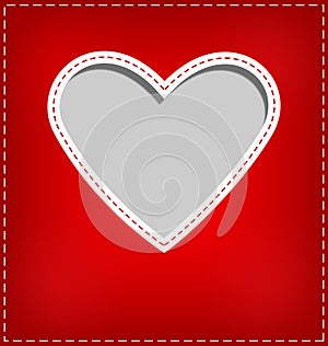 Heart cutout in red card on grey photo