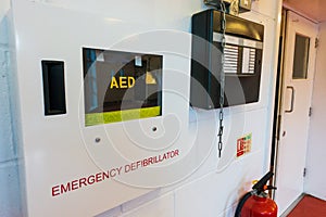 Heart defibrillator hanging on the wall in international school or office location for prepared to provide life-saving