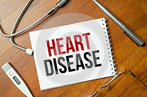 Heart disease with notepad with stethoscope on desk