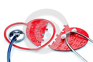 Heart disease, Split heart-shaped puzzle with stethoscope
