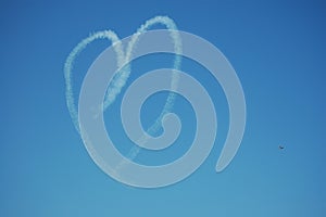 Heart. Drawing by airplane vapor contrail in blue sky