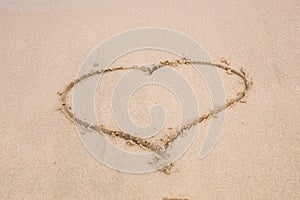 Heart drawing in the sand on a beach