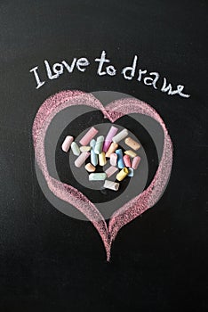 Heart drawn on the blackboard with chalk.