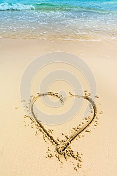 Heart drawn on caribbean white sand