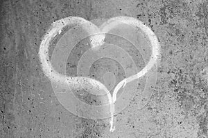 Heart drawn in chalk on a gray concrete wall